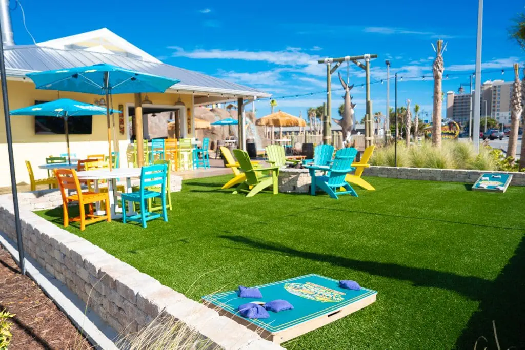 outside seating area with cornhole game
